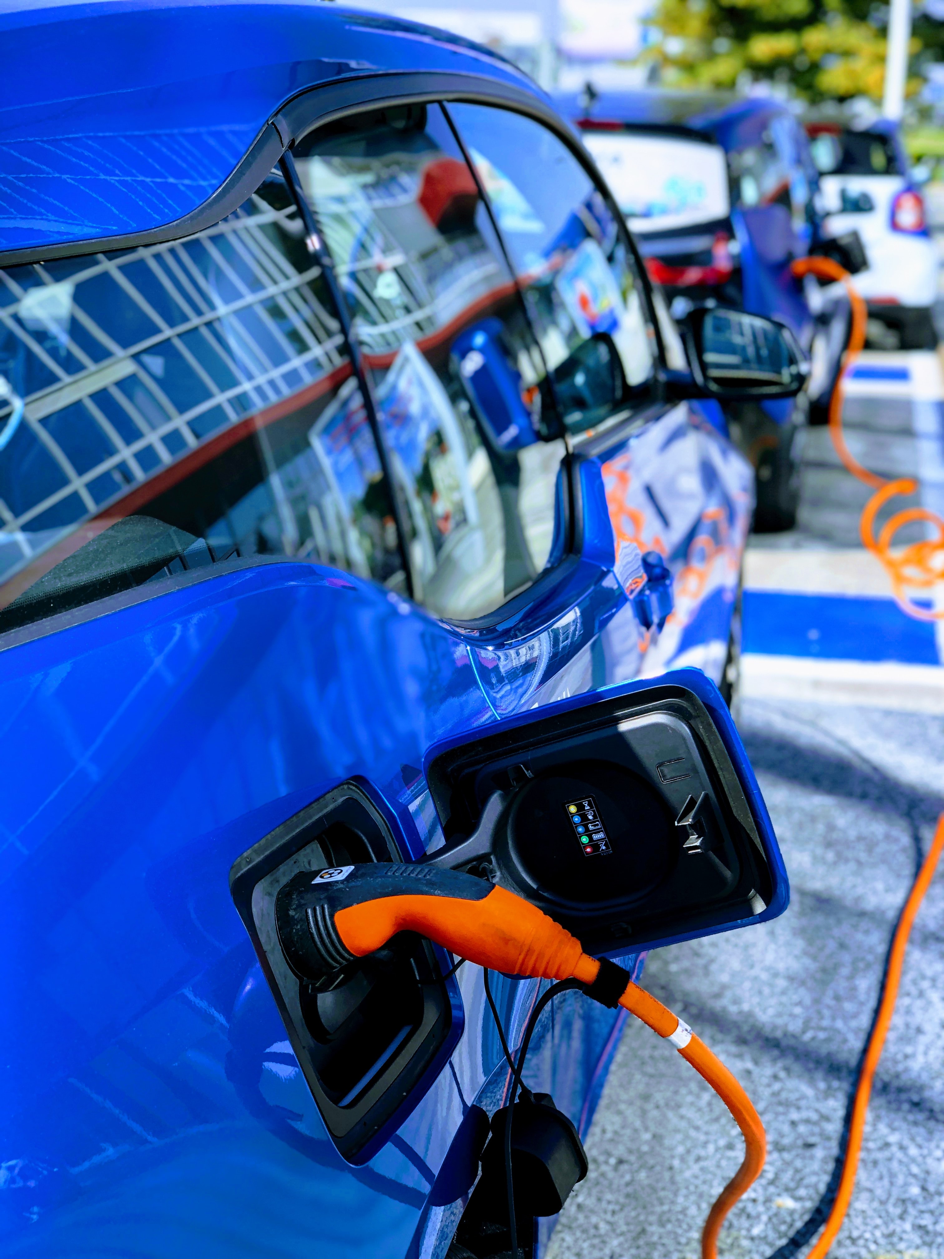 Photograph of electric vehicles charging. John Cameron / Unsplash